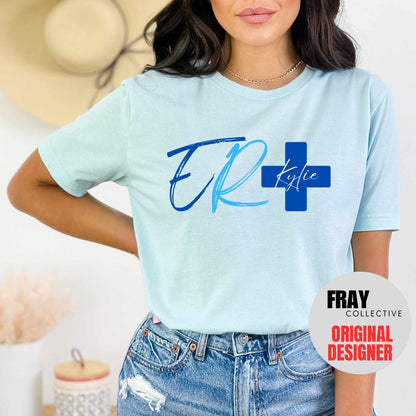 Personalized ER nurse/tech shirt—navy tee with modern ER lettering and blue cross showing custom name and credentials; great for emergency department teams.