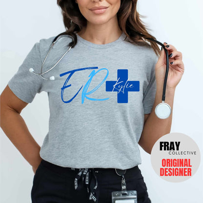 Personalized ER nurse/tech shirt—navy tee with modern ER lettering and blue cross showing custom name and credentials; great for emergency department teams.