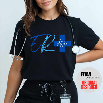 Personalized ER nurse/tech shirt—navy tee with modern ER lettering and blue cross showing custom name and credentials; great for emergency department teams.